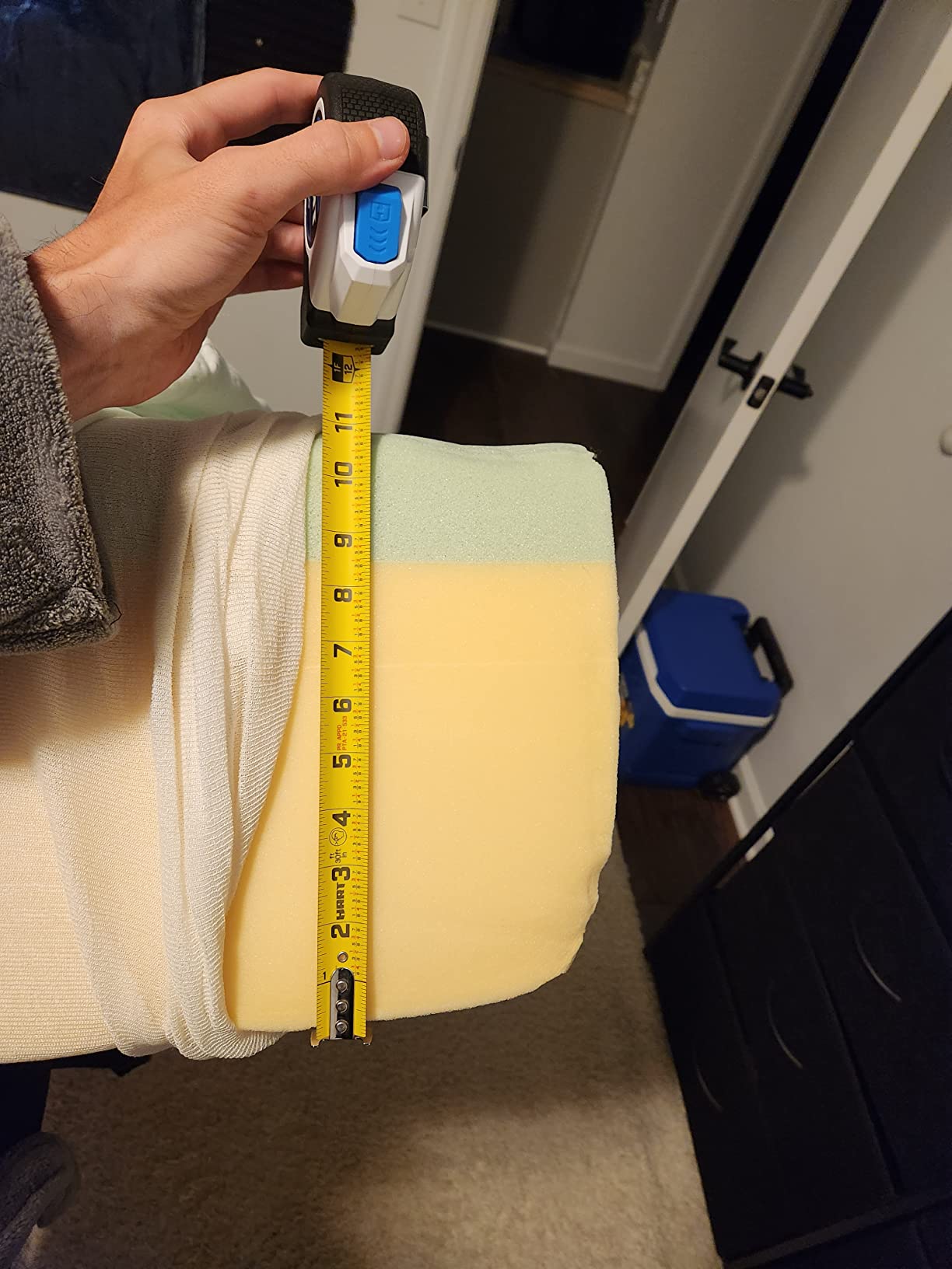 Measuring mattress thickness showing internal layers of a Zinus mattress